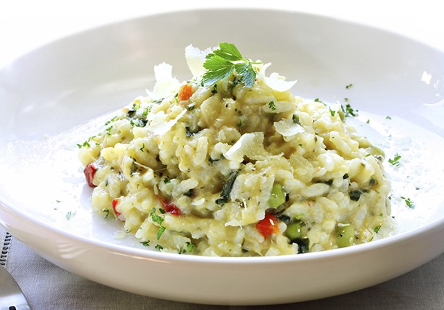 Delicious risotto, topped with shaved parmesan cheese and parsley.