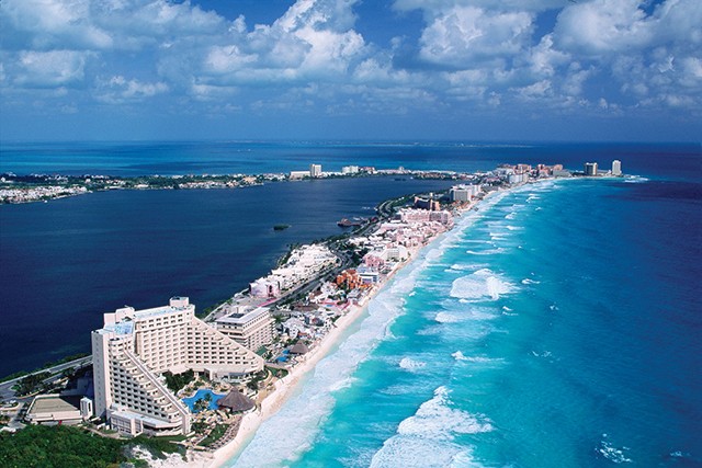 An aerial view of the Hotel Zone of Cancun, Mexico and the blue waters of the Gulf of Mexico. Hotels and tourist facilities crowd the narrow, 21-mile sandbar on the Yucatan coast, one of Mexico's most popular vacation spots. November 18, 1995 Cancun, Mexico