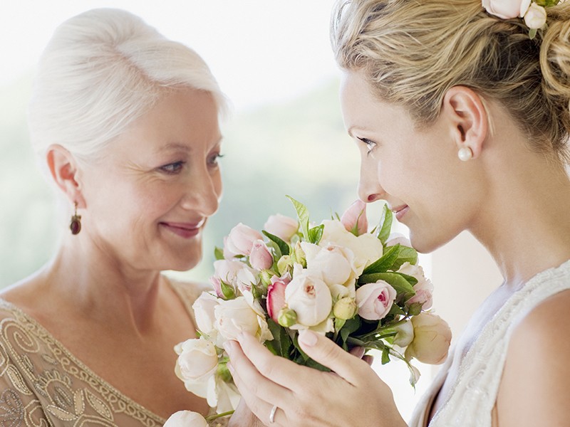 Mother and bride smelling bouquet
