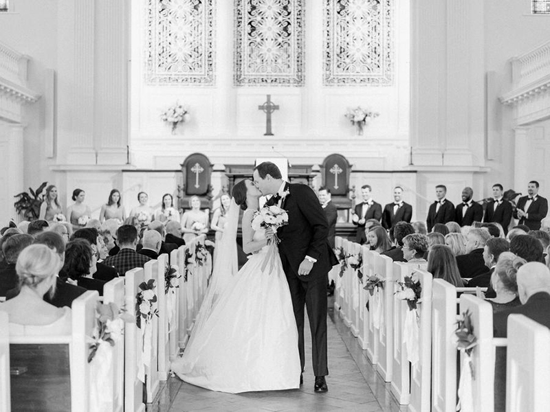 foto de casal composto por mulher e homem se beijando na saída do casamento
