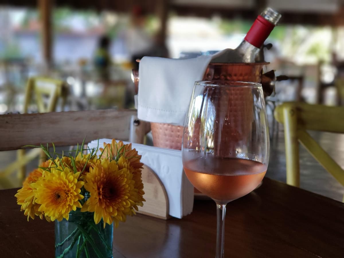 Imagem de uma mesa com taça e vinho