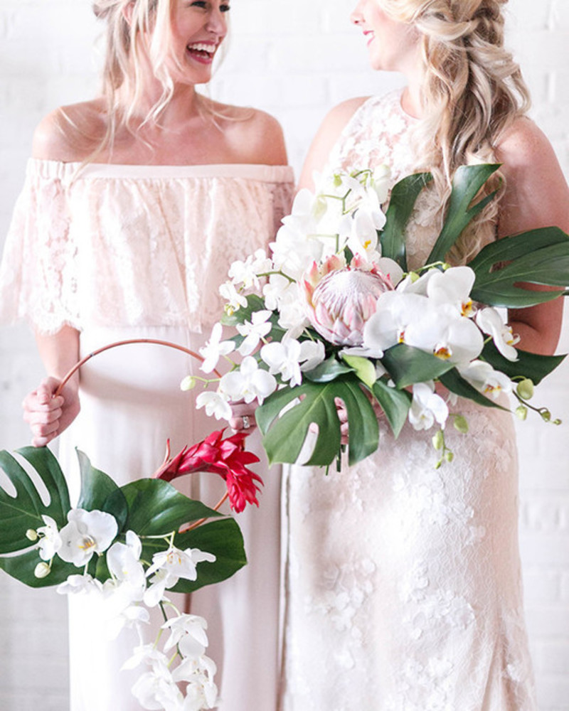Buquê de noiva em arco com grande concentração de flores no topo